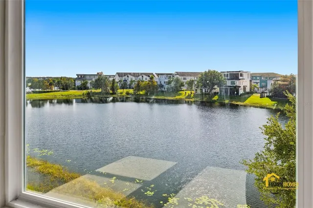 a view of a lake with houses in the back