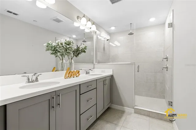 a bathroom with a granite countertop sink a shower and a mirror