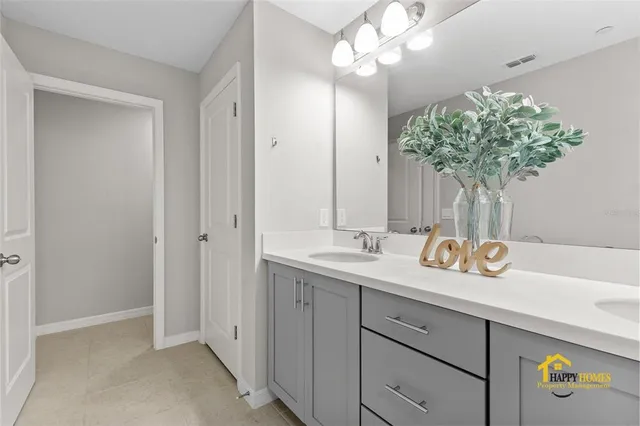 a bathroom with a sink a vanity and a mirror