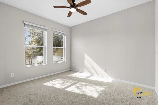 a view of a livingroom with a ceiling fan and window