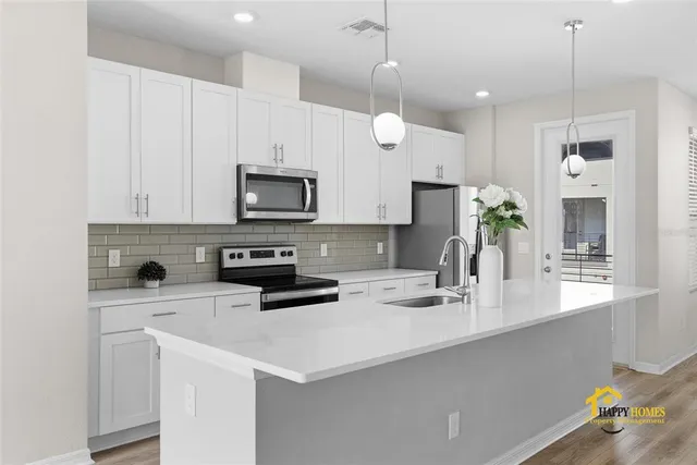 a kitchen with a sink a microwave and wooden cabinets