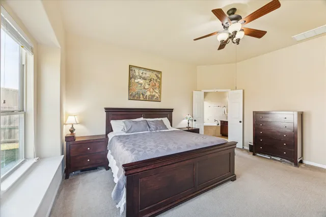 a spacious bedroom with a bed and a desk