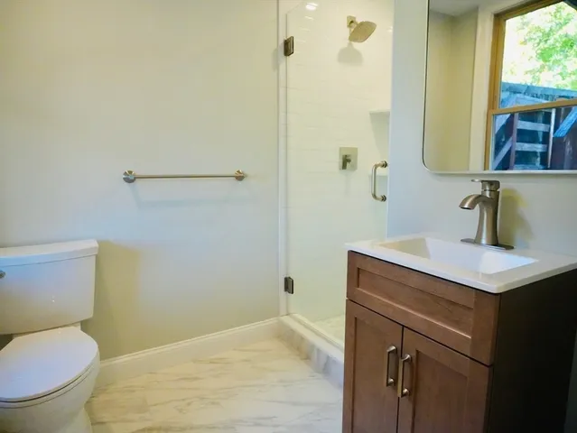 a bathroom with a sink toilet and shower