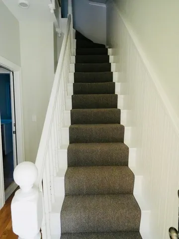 a view of staircase with white walls