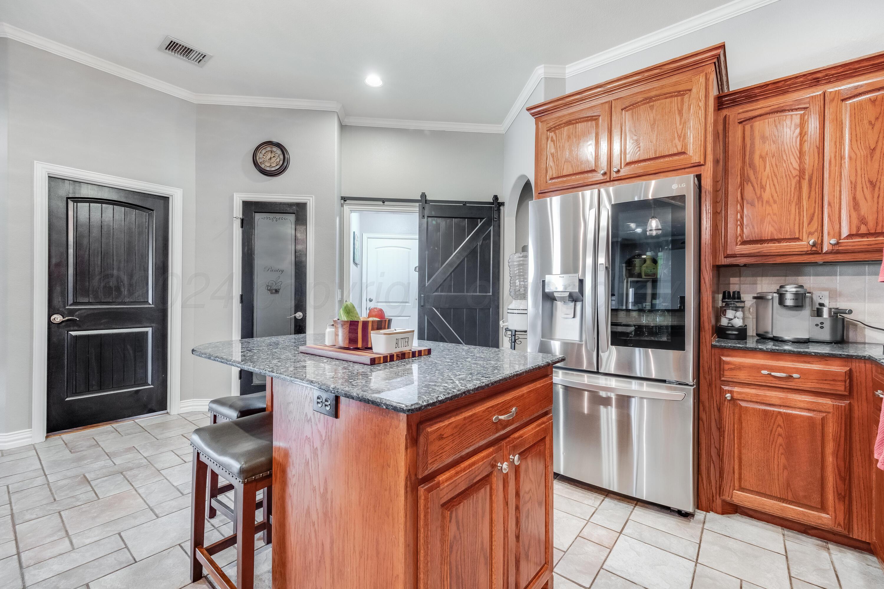 8413 Hamilton Drive Amarillo, TX 79119 - Photo 11 of 54 a kitchen with stainless steel appliances granite countertop a refrigerator and a sink