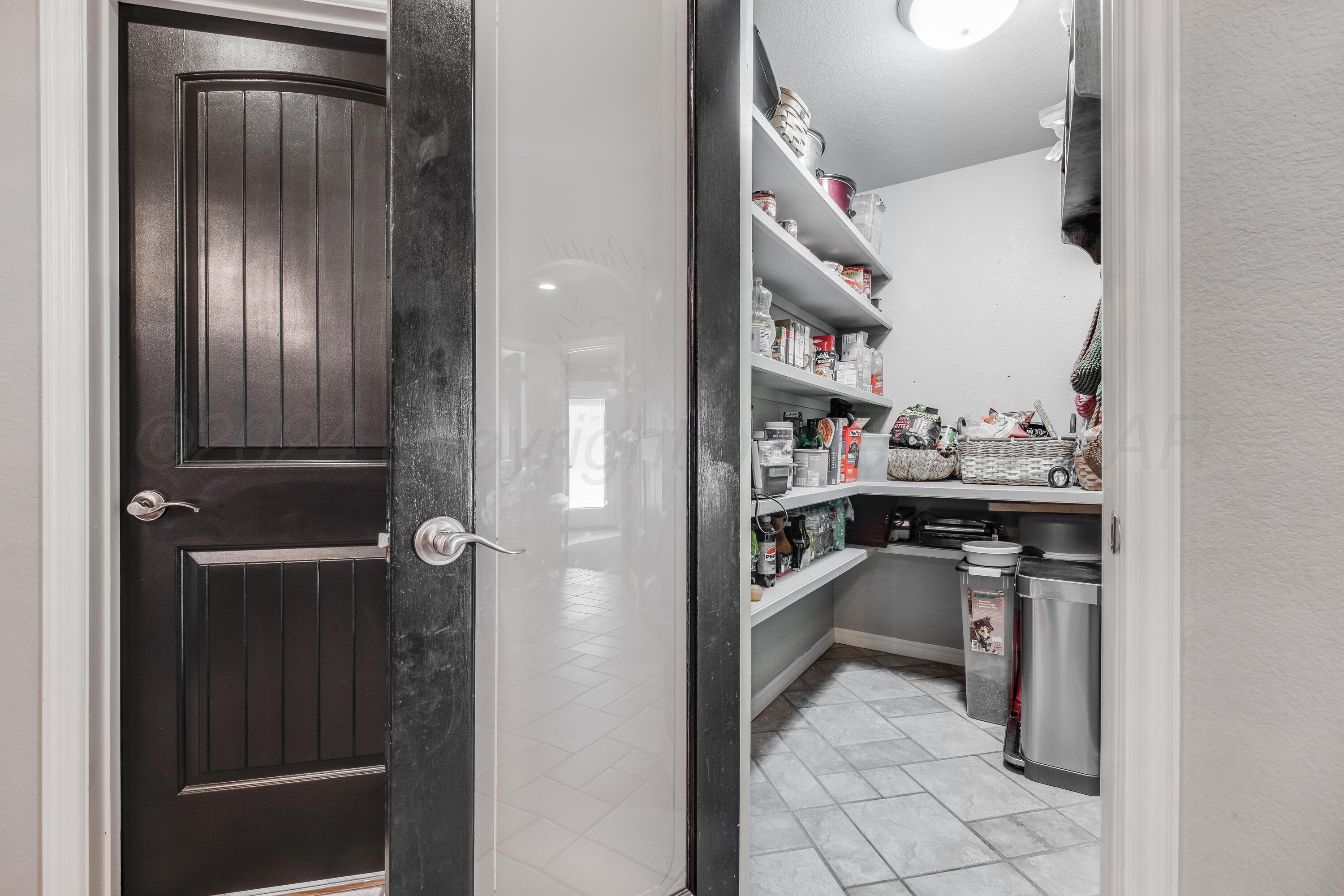 8413 Hamilton Drive Amarillo, TX 79119 - Photo 14 of 54 a view of cabinets and refrigerator in kitchen