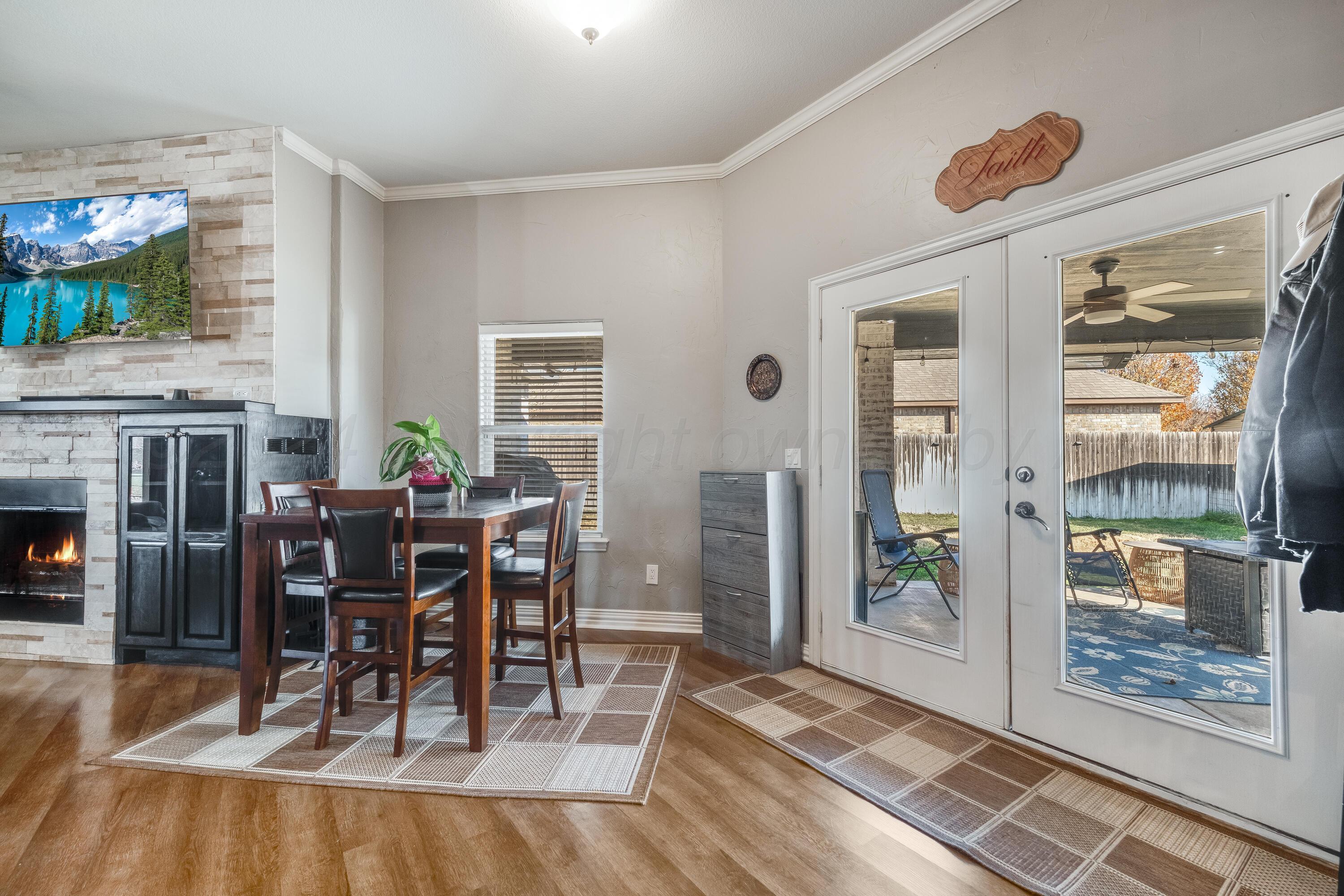 8413 Hamilton Drive Amarillo, TX 79119 - Photo 15 of 54 a view of a dining room with furniture window and wooden floor