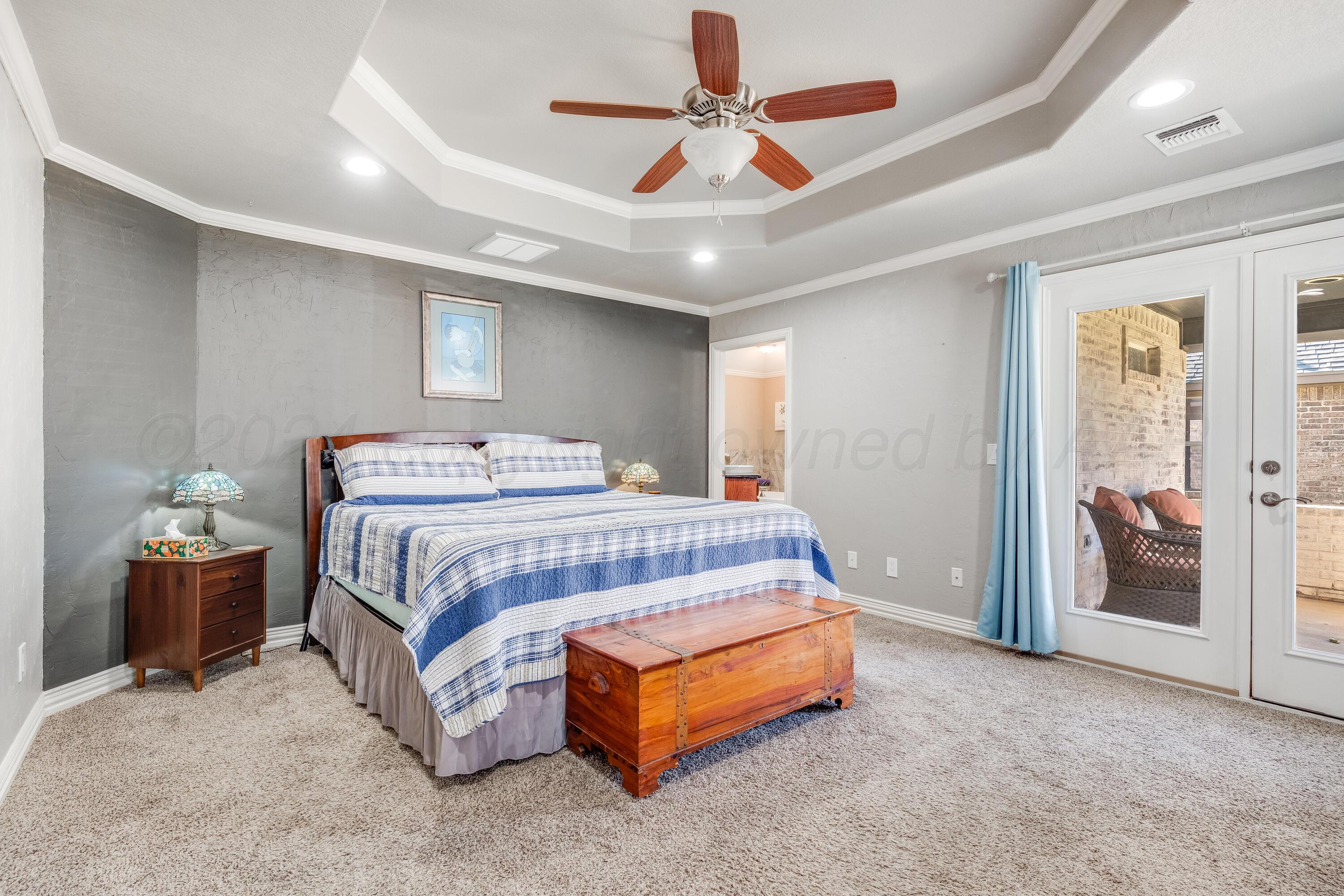 8413 Hamilton Drive Amarillo, TX 79119 - Photo 17 of 54 a bedroom with a bed and a chandelier