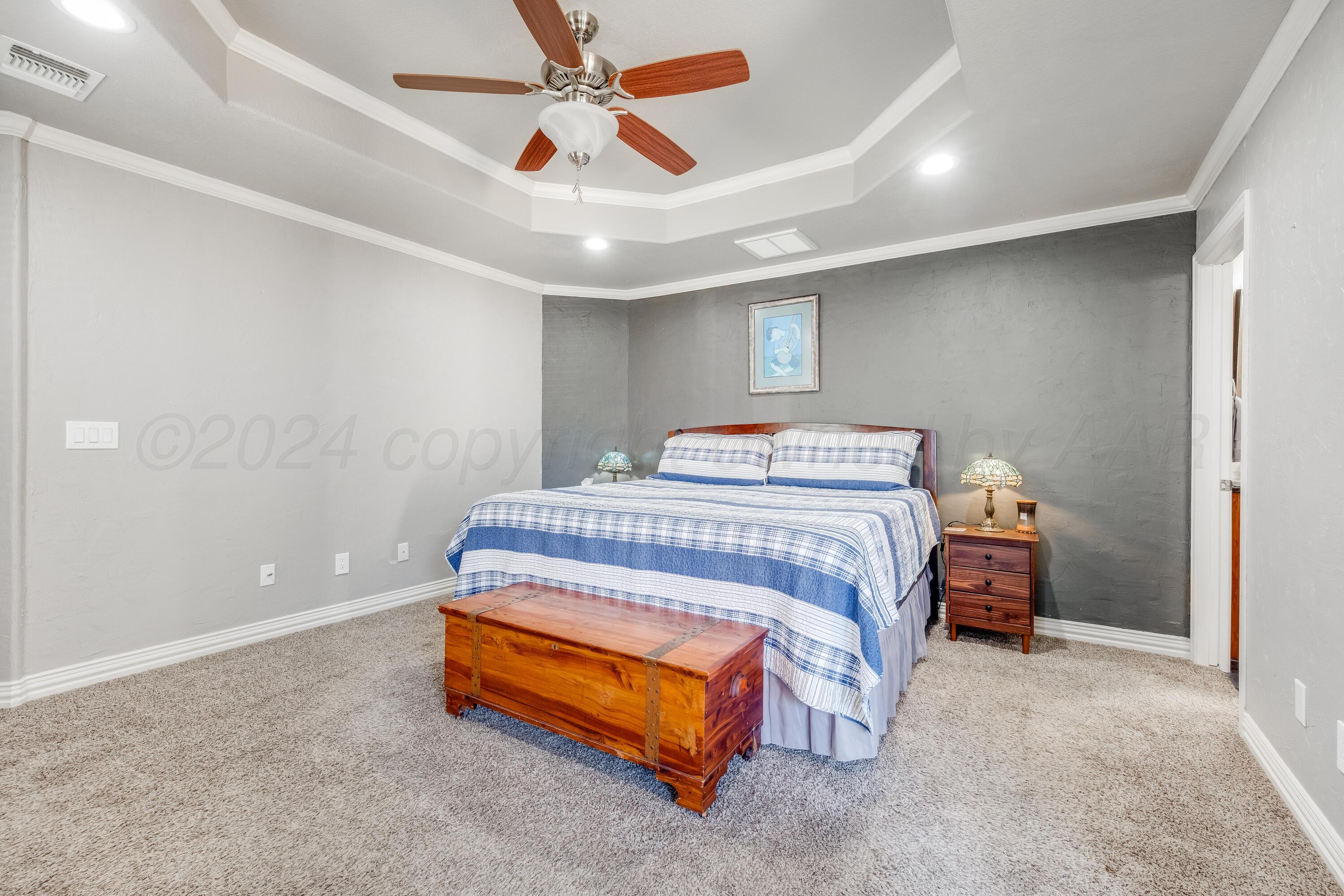 8413 Hamilton Drive Amarillo, TX 79119 - Photo 18 of 54 a bedroom with a bed and a chandelier