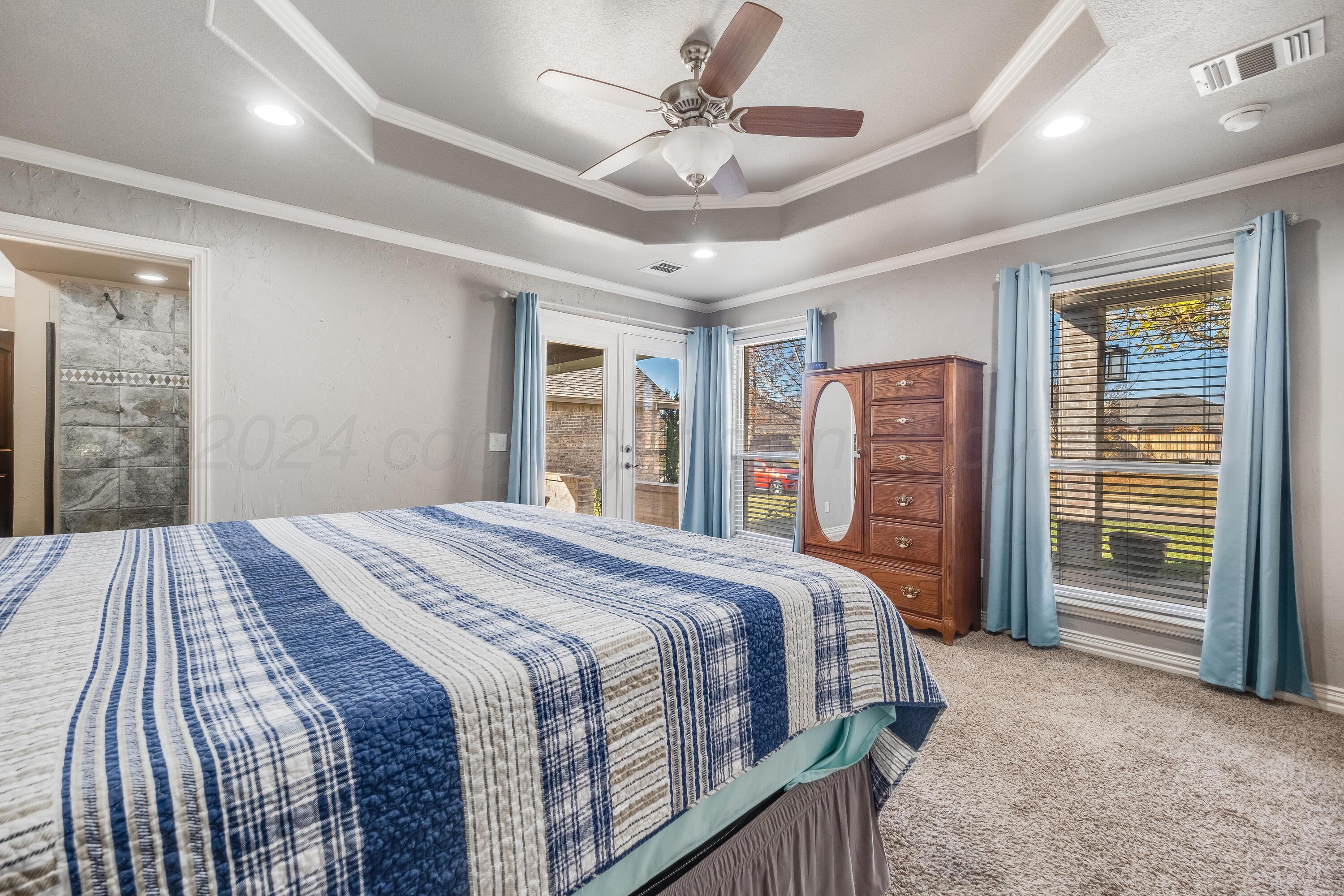 8413 Hamilton Drive Amarillo, TX 79119 - Photo 19 of 54 a bedroom with a large bed and a chandelier