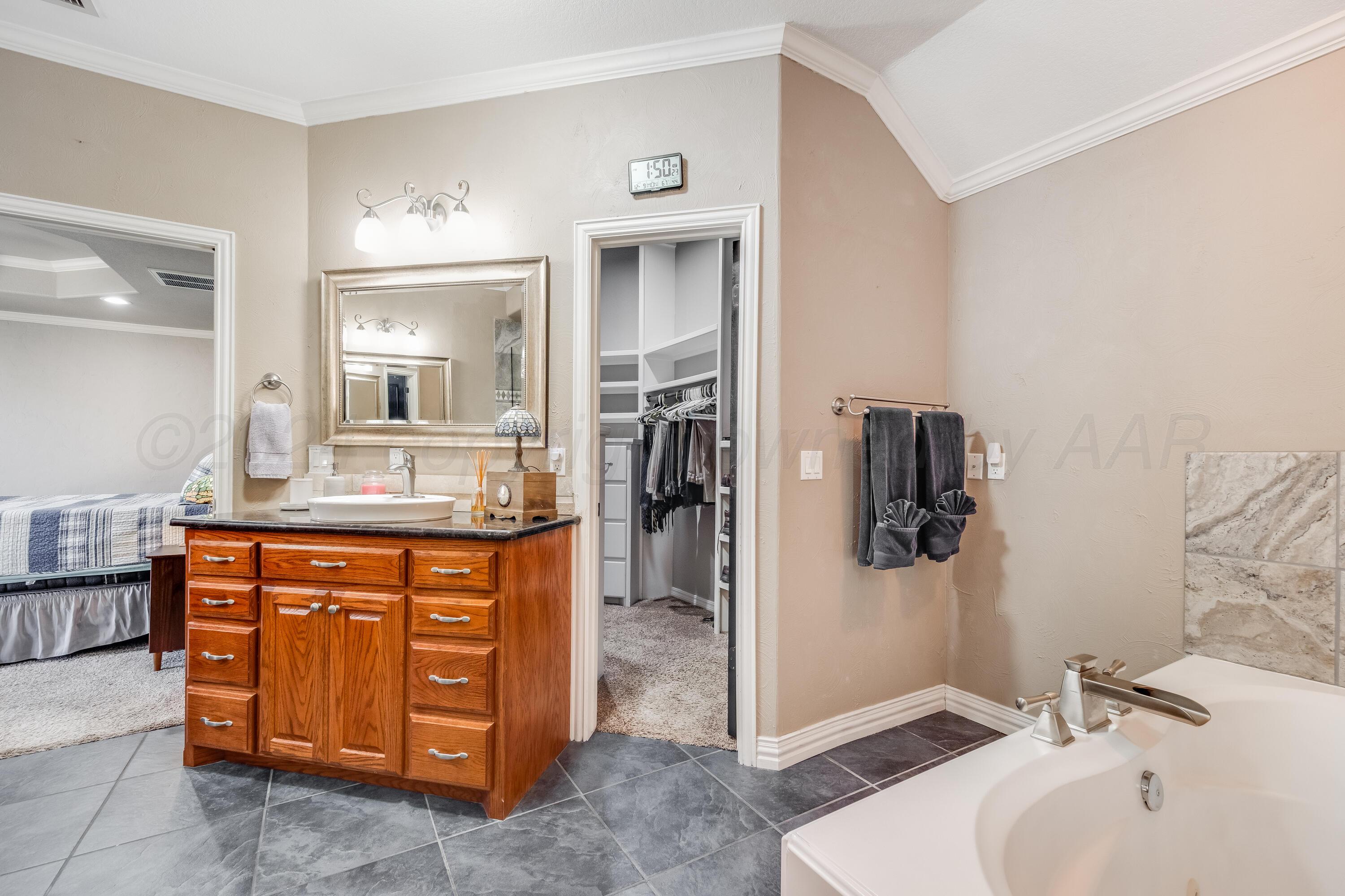 8413 Hamilton Drive Amarillo, TX 79119 - Photo 24 of 54 a bathroom with a sink and a mirror