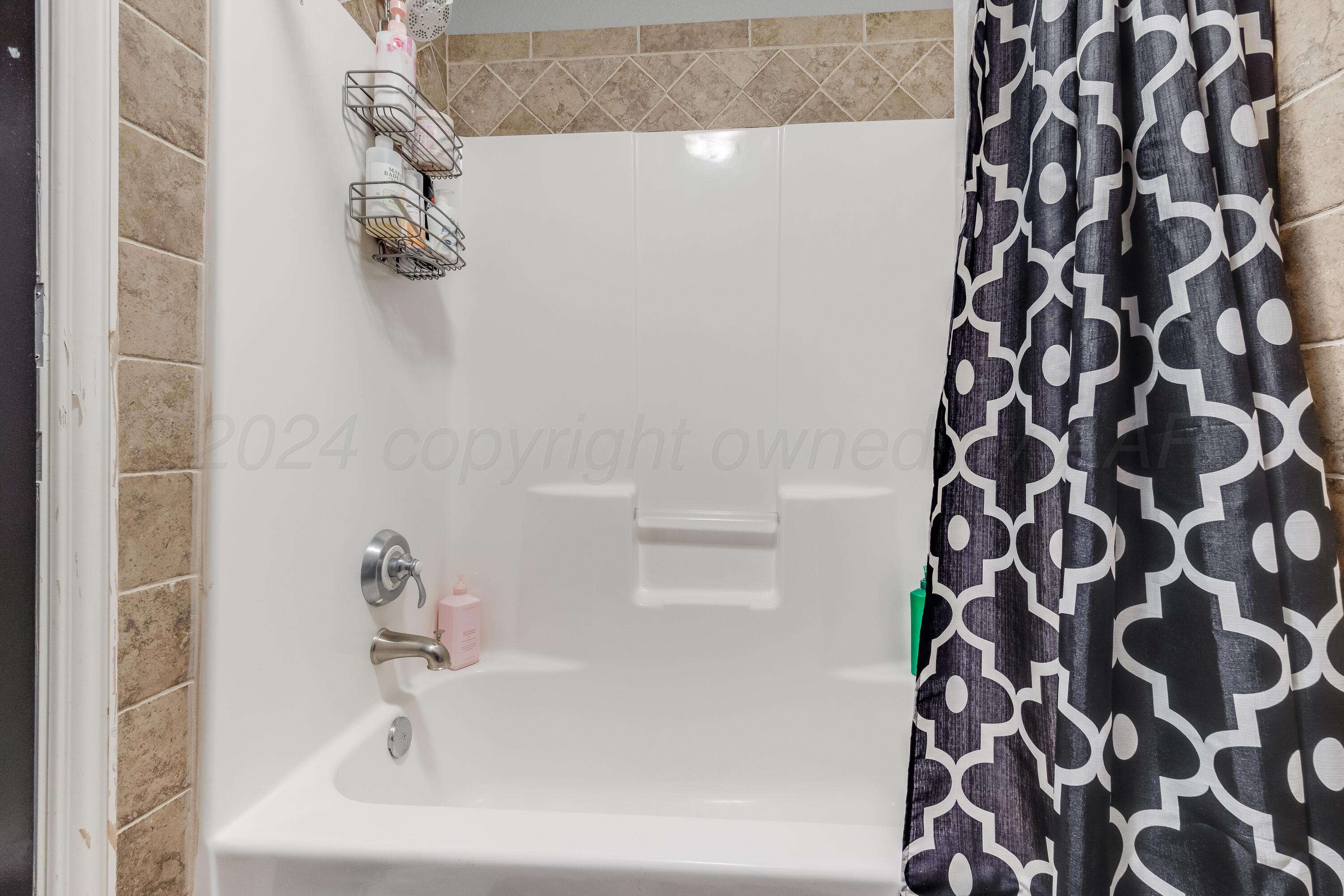 8413 Hamilton Drive Amarillo, TX 79119 - Photo 32 of 54 a bathroom with a sink and a shower