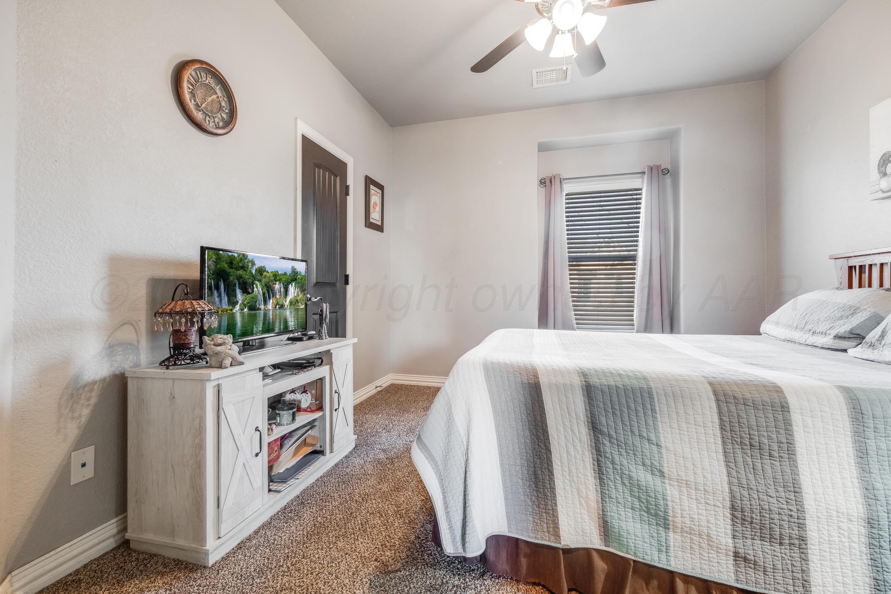 8413 Hamilton Drive Amarillo, TX 79119 - Photo 34 of 54 a bedroom with a bed and a chandelier