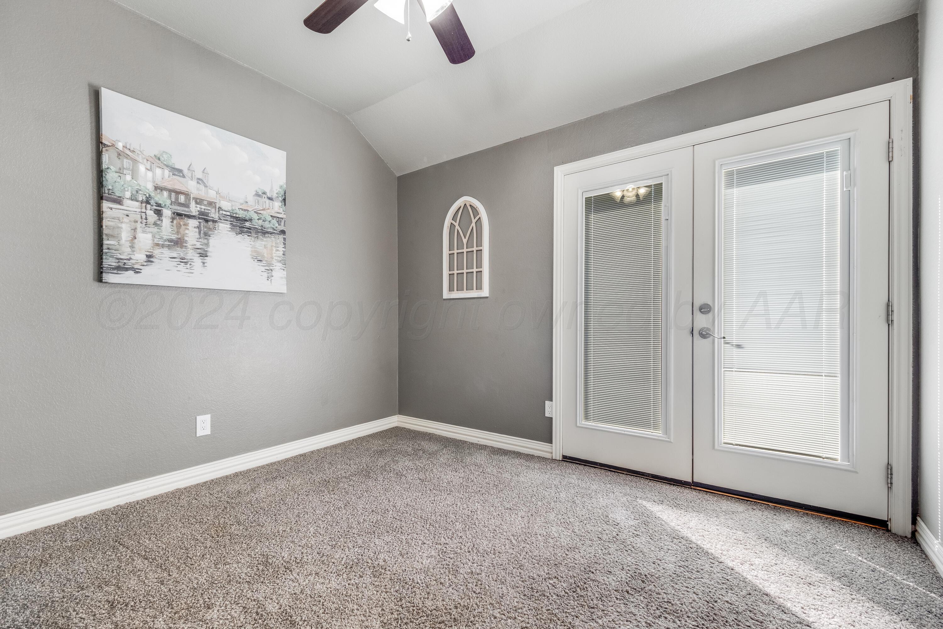 8413 Hamilton Drive Amarillo, TX 79119 - Photo 38 of 54 an empty room with windows and cabinet