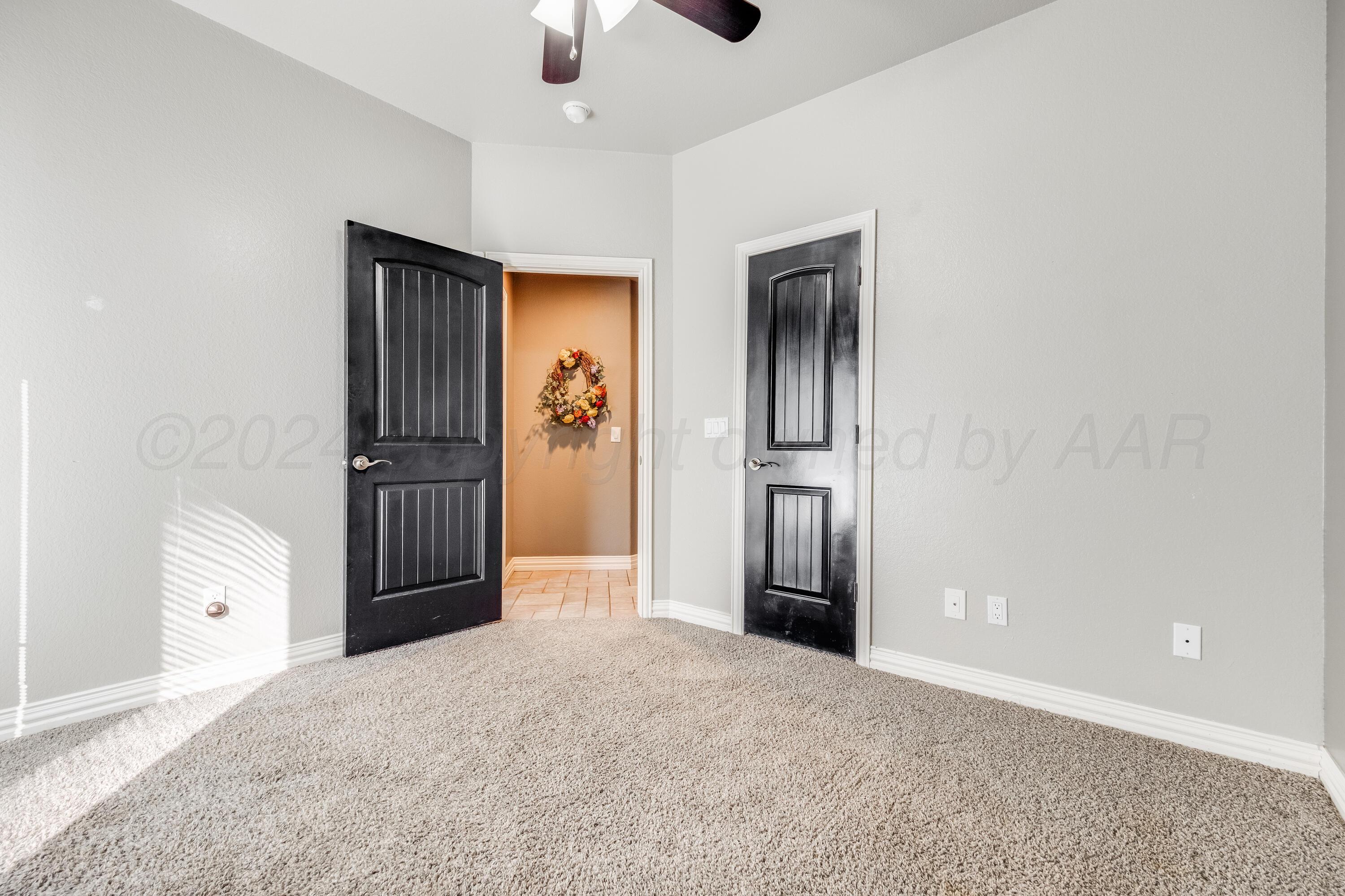 8413 Hamilton Drive Amarillo, TX 79119 - Photo 39 of 54 an empty room with closet and a ceiling fan