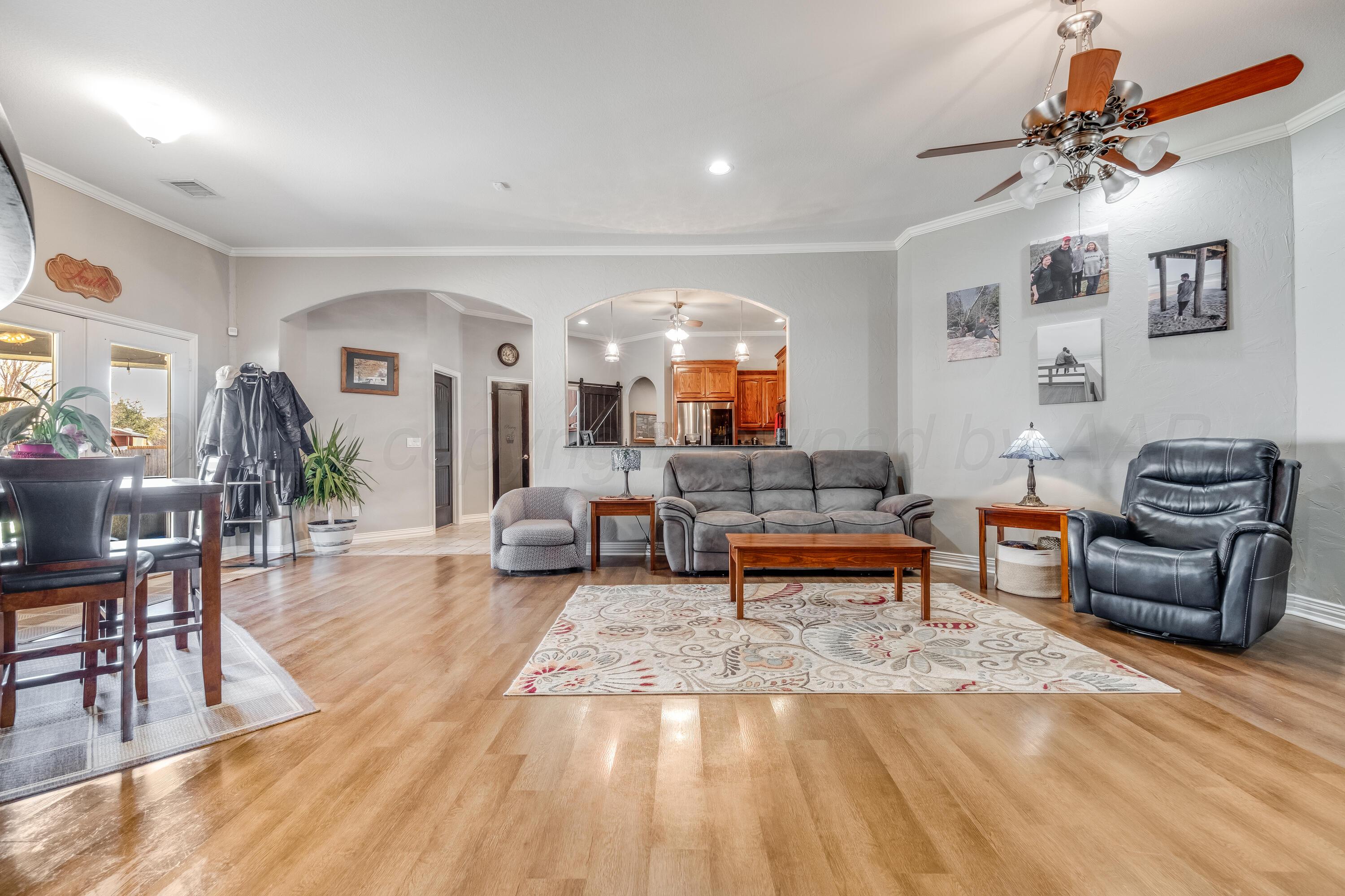 8413 Hamilton Drive Amarillo, TX 79119 - Photo 6 of 54 a living room with furniture and wooden floor