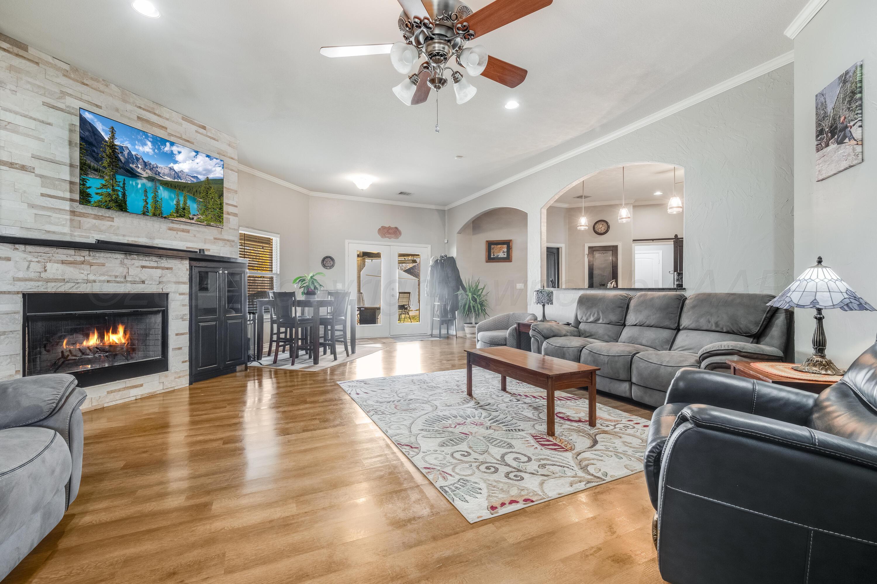 8413 Hamilton Drive Amarillo, TX 79119 - Photo 7 of 54 a living room with furniture and a fireplace