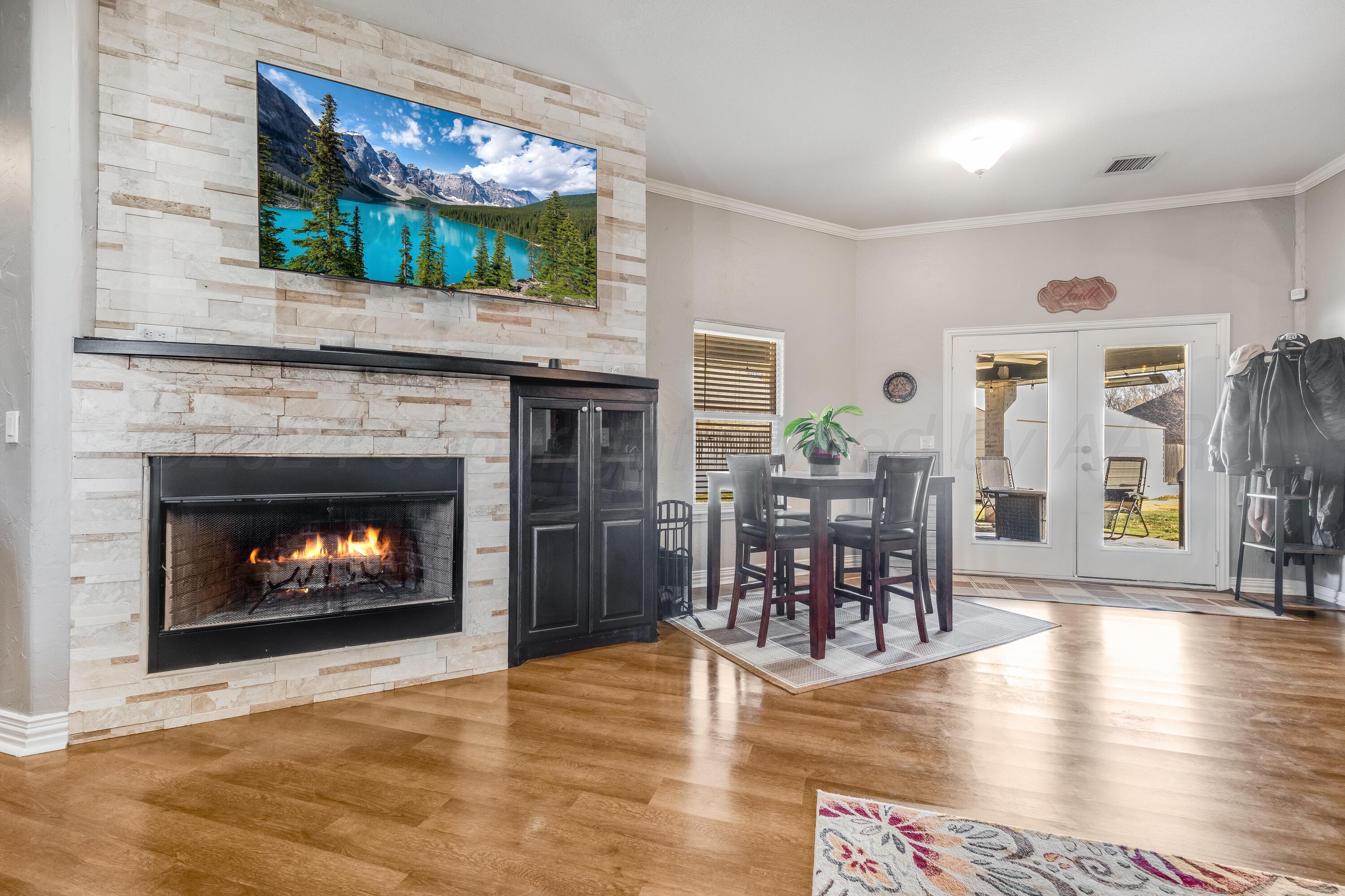 8413 Hamilton Drive Amarillo, TX 79119 - Photo 8 of 54 a living room with furniture a fireplace and a flat screen tv