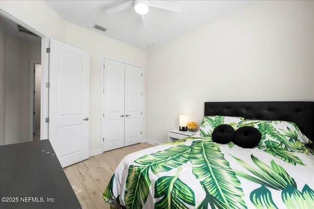 a bedroom with a bed and a painting on the wall