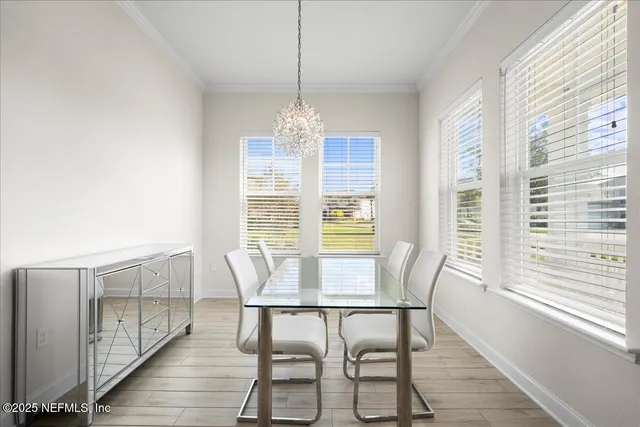 a view of a dining room with furniture windows and wooden floor