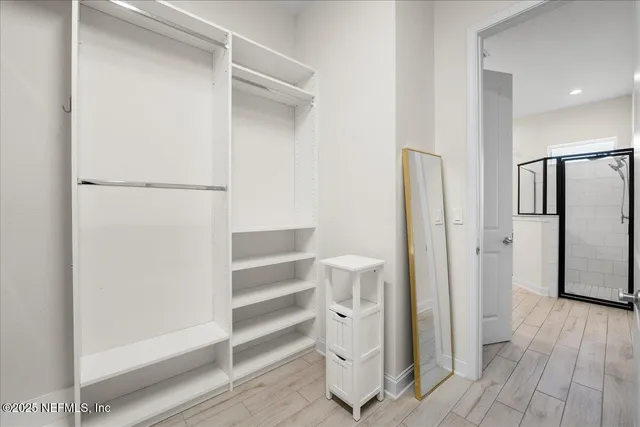 a view of walk in closet with empty racks