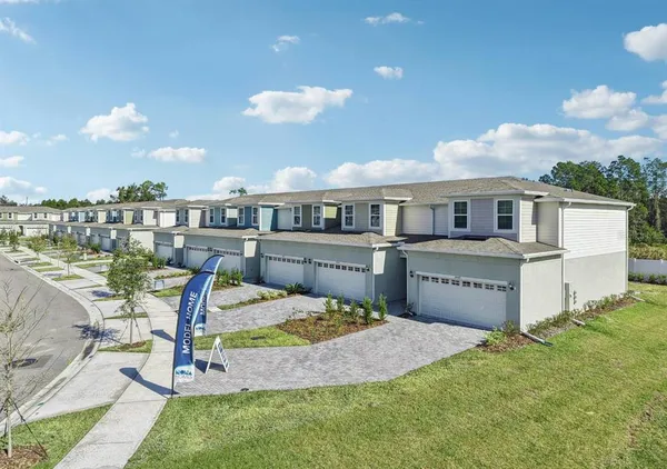 a view of a house with pool and chairs