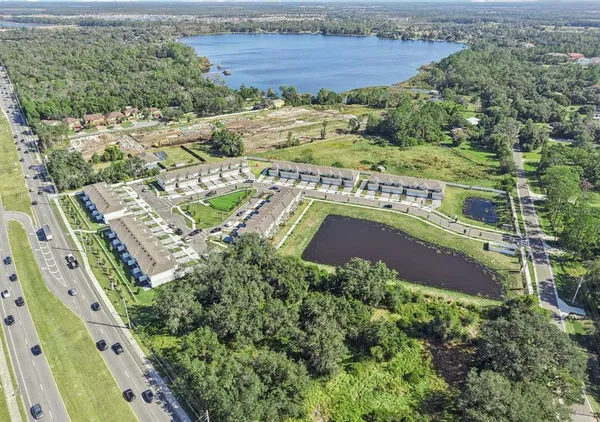 an aerial view of residential houses with outdoor space