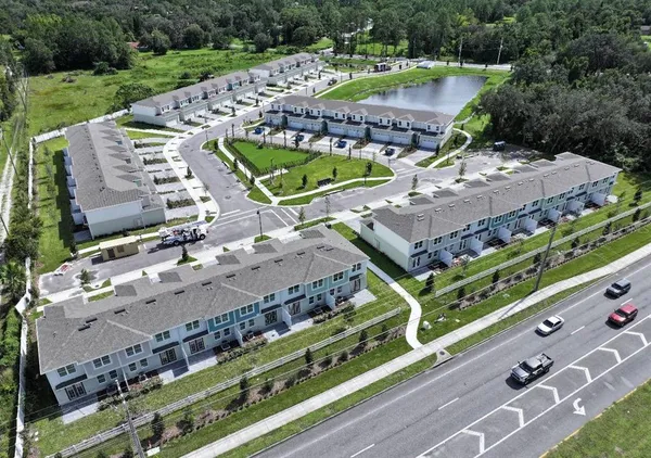 a view of a tennis ground with a large trees