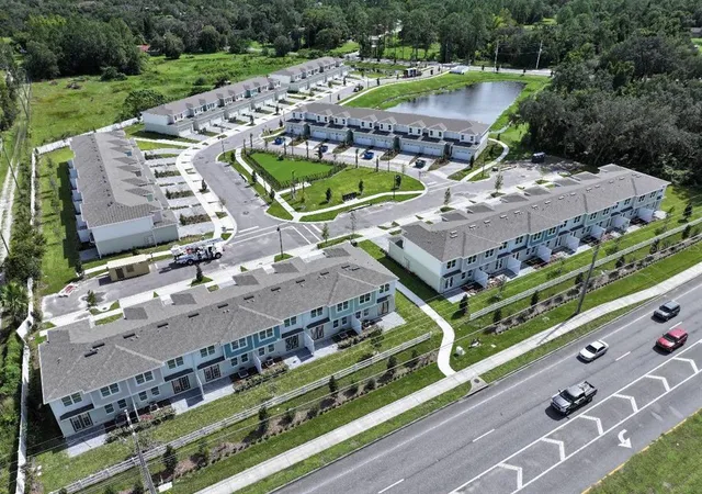 a view of a tennis ground with a large trees