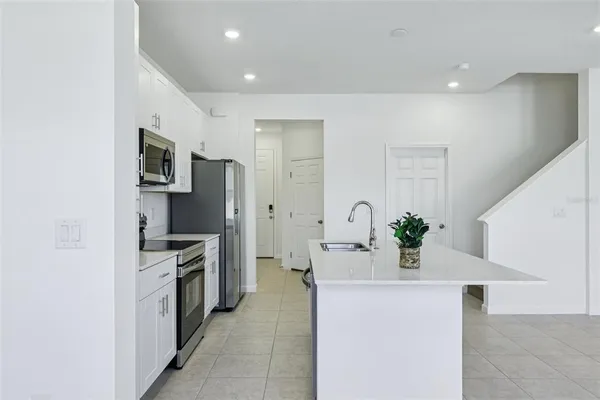 a kitchen with stainless steel appliances a refrigerator sink and stove