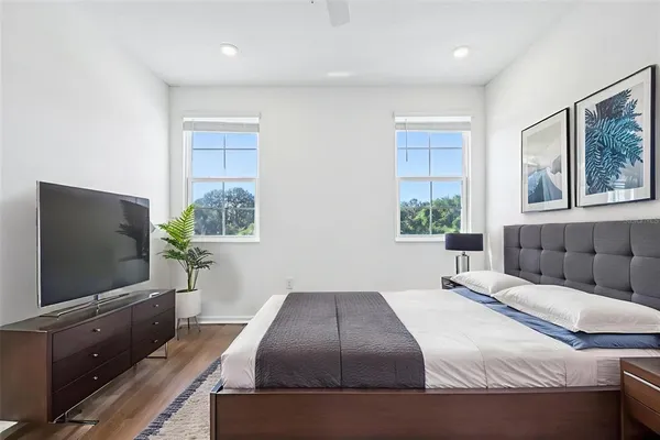 a bedroom with a large bed and a flat screen tv