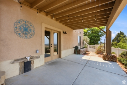 722 West Webb Circle, Unit 2 Draper, UT 84020 - Photo 30 of 39 Covered concrete patio with exposed beam ceiling, double glass doors, stucco exterior, and privacy fencing