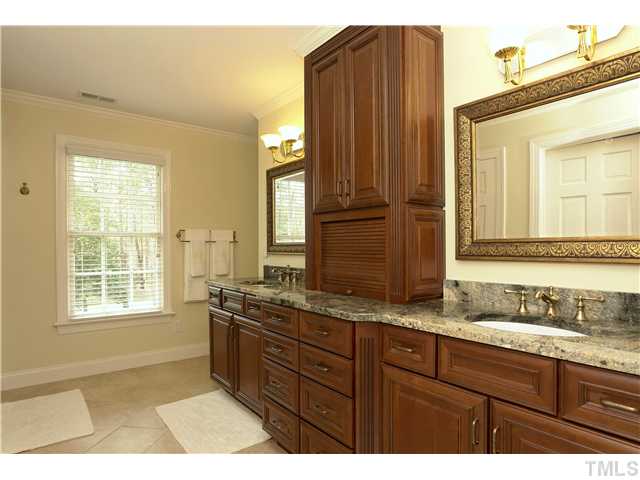 10028 Old Warden Road Raleigh, NC 27615 - Photo 18 of 25 a bathroom with a granite countertop double vanity sink and mirror