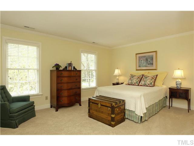 10028 Old Warden Road Raleigh, NC 27615 - Photo 19 of 25 a spacious bedroom with a bed and a couch