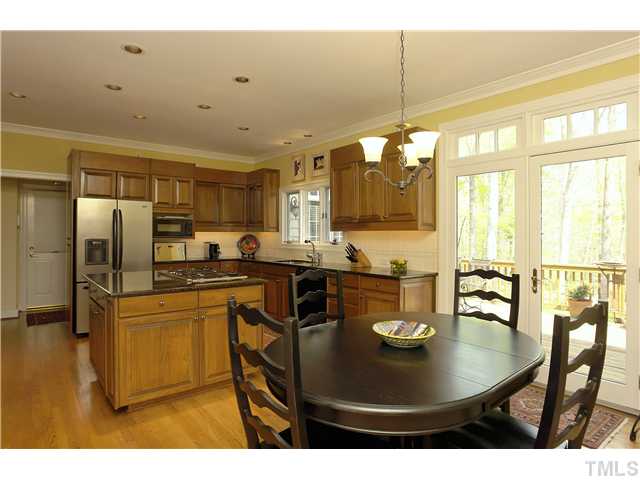 10028 Old Warden Road Raleigh, NC 27615 - Photo 10 of 25 a kitchen with stainless steel appliances granite countertop a sink a stove and refrigerator