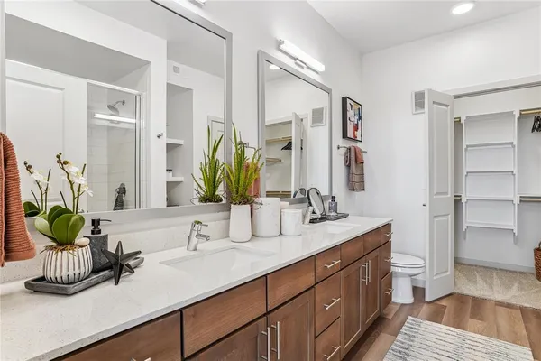 a bathroom with a double vanity sink and a mirror