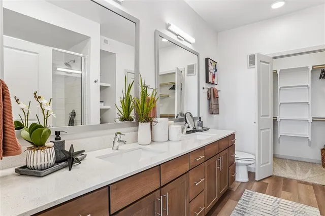 a bathroom with a double vanity sink and a mirror