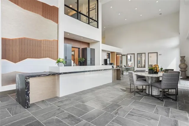 a living room with granite countertop furniture and a kitchen view