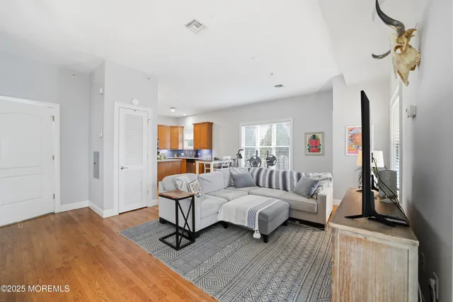 a bedroom with furniture and a wooden floor