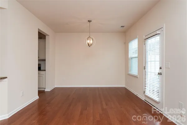 a view of a room with wooden floor and windows