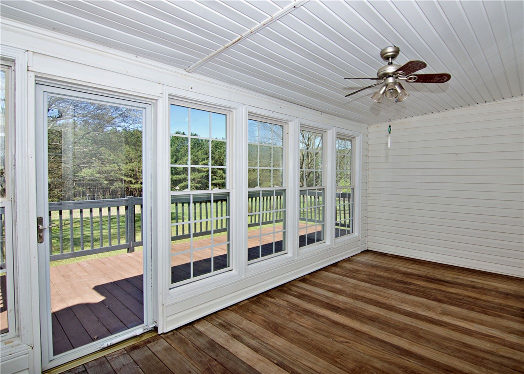 7893 Athens Road Carnesville, GA 30521 - Photo 11 of 50 This bright sunroom offers expansive views and seamless outdoor access.