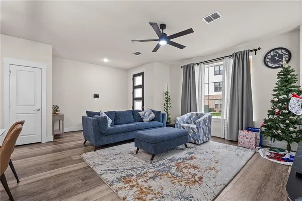 a living room with furniture and a potted plant