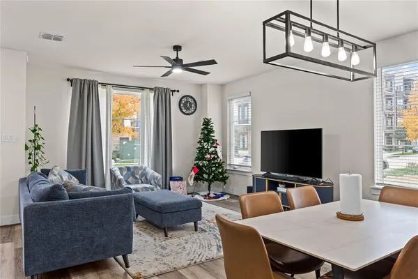 a living room with furniture a window and a flat screen tv