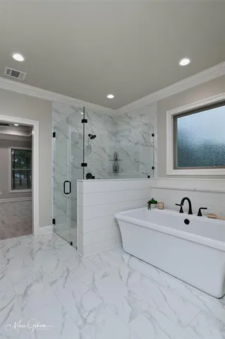 a bathroom with a tub sink and mirror