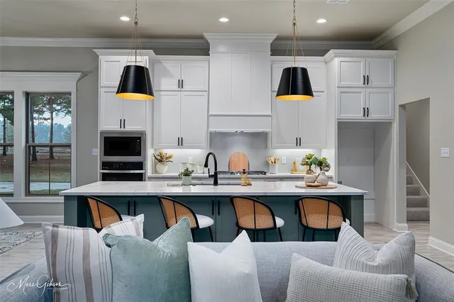 a kitchen with stainless steel appliances kitchen island granite countertop a sink and a refrigerator