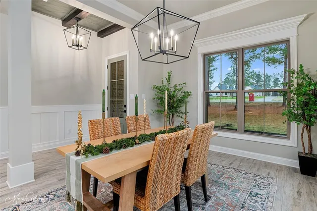 a view of a dining room with furniture wooden floor and chandelier