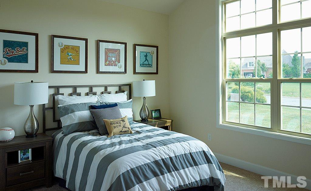 7414 Randshire Way Raleigh, NC 27616 - Photo 2 of 25 a bedroom with a bed and wooden floor