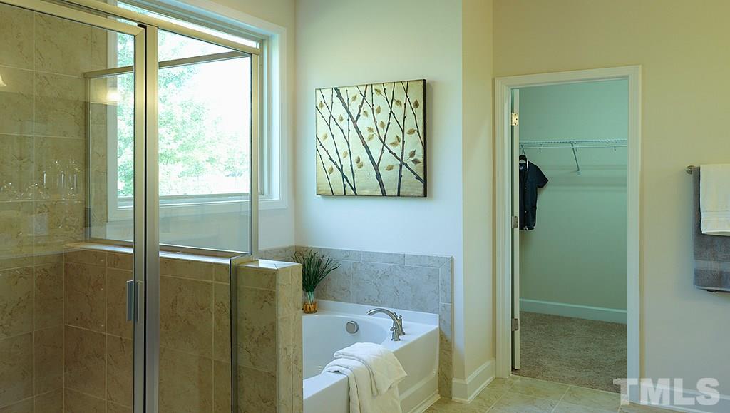 7414 Randshire Way Raleigh, NC 27616 - Photo 11 of 25 a bathroom with a bathtub and a shower