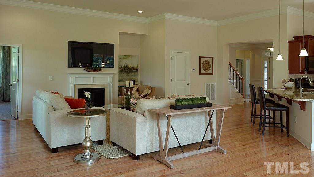 7414 Randshire Way Raleigh, NC 27616 - Photo 10 of 25 a living room with furniture a flat screen tv and kitchen view