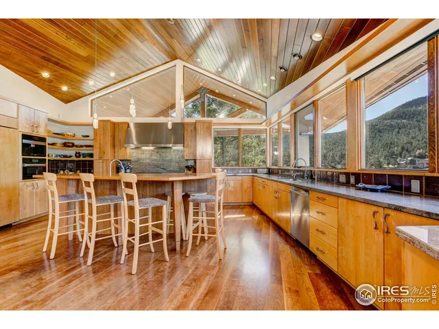 a dining room with stainless steel appliances kitchen island granite countertop a table and chairs